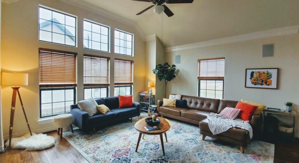 A grid of windows floods their new home's living room with light.